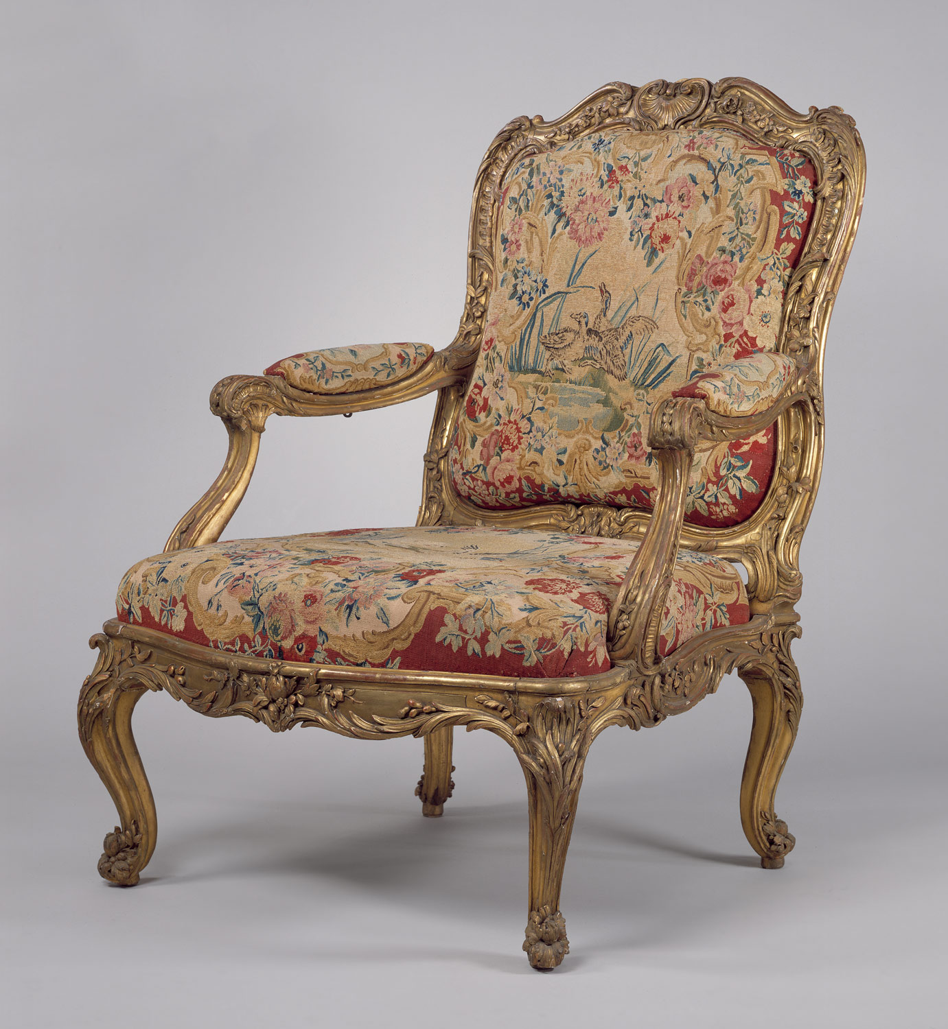 Armchair (fauteuil à la reine) (part of a set), frame by Nicolas-Quinibert Foliot, probably after a design by Pierre Contant d'Ivry, after designs by Jean-Baptiste Oudry, tapestry woven at Beauvais, ca. 1754-56, Paris. 40 7/8 × 29 × 26 in. Carved and gilded beech; wool and silk tapestry. Photo: Metropolitan Museum of Art, New York (66.60.2). 